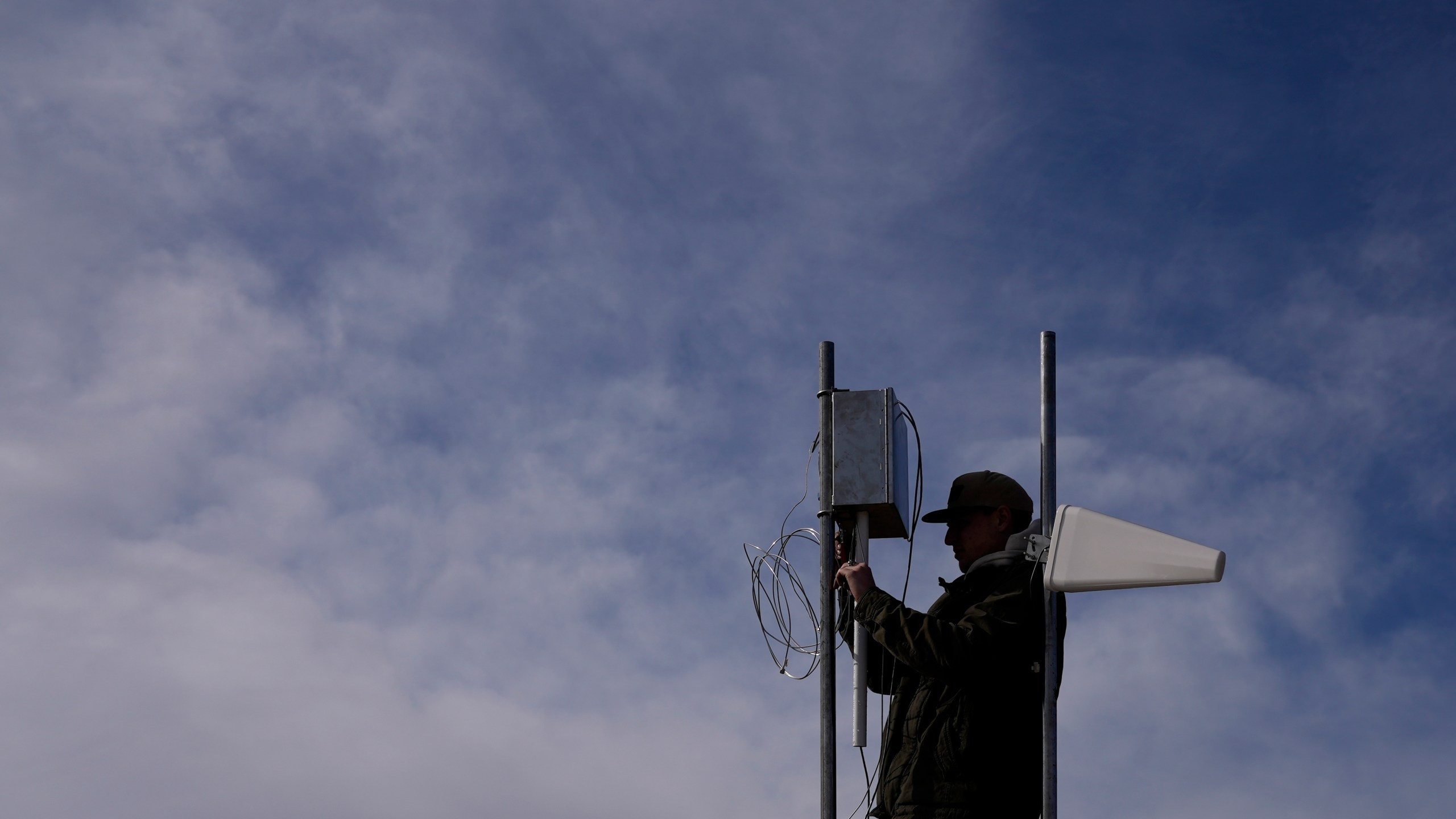 FILE - Carver Cammans installs cloud seeding equipment, Dec. 3, 2022, in Lyons, Colo. (AP Photo/Brittany Peterson, File)