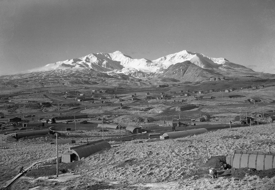 FILE - This is a general view of the Army's task force Williwaw camp on Alaska's Adak Island, shown Feb. 3, 1947, with Mount Moffett in background. The Quonset huts were dug in as protection against the winds. (AP Photo/Joseph D. Jamieson, File)