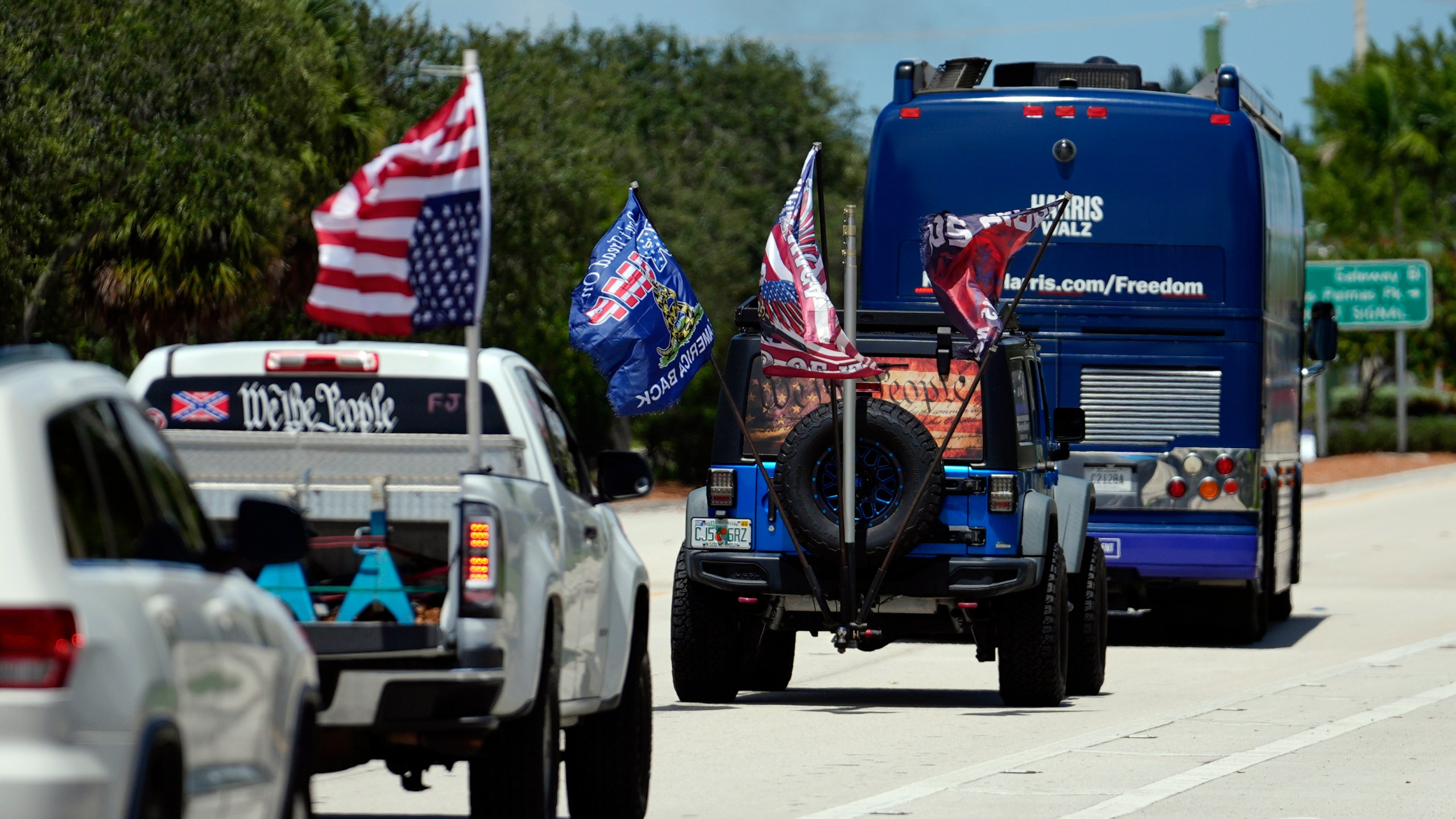 Trump supporters who turned out to protest against abortion follow the bus at the start of the "Reproductive Freedom Bus Tour" by the campaign of Democratic presidential nominee Vice President Kamala Harris and running mate Gov. Tim Walz, Tuesday, Sept. 3, 2024, in Boynton Beach, Fla. (AP Photo/Rebecca Blackwell)