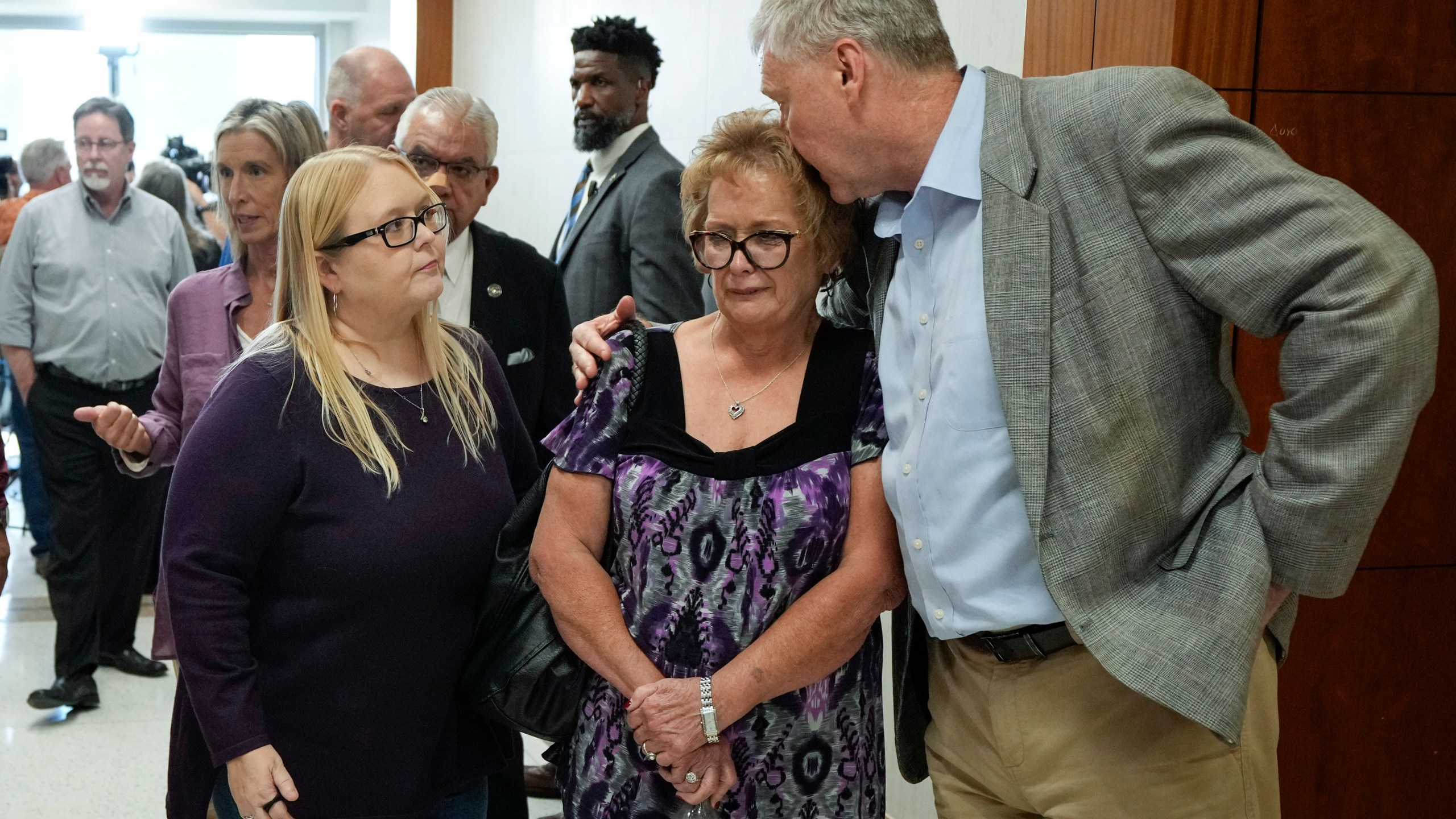 The family of Dennis Tuttle and Rhogena Nicholas gather outside the courtroom after former Houston police officer Gerald Goines was sentenced to 60 years behind bars on a pair of felony murder convictions on Tuesday, Oct. 8, 2024, in Houston. Goines was found guilty of felony murder in the 2019 deaths of Tuttle and Nicholas. (Brett Coomer/Houston Chronicle via AP)