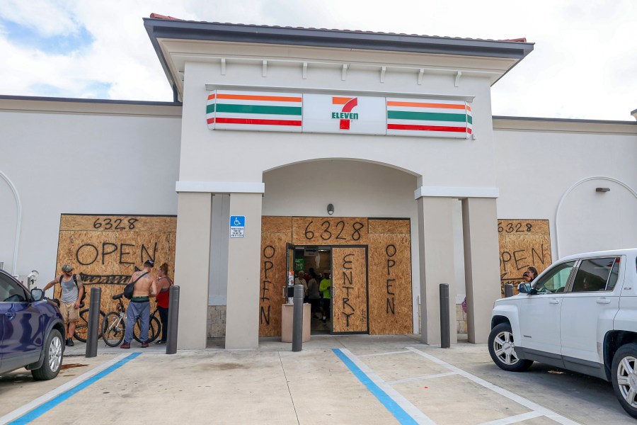 A store boards up but remains open in preparation for Hurricane Milton on Tuesday, Oct. 8, 2024, in New Port Richey, Fla. (AP Photo/Mike Carlson)