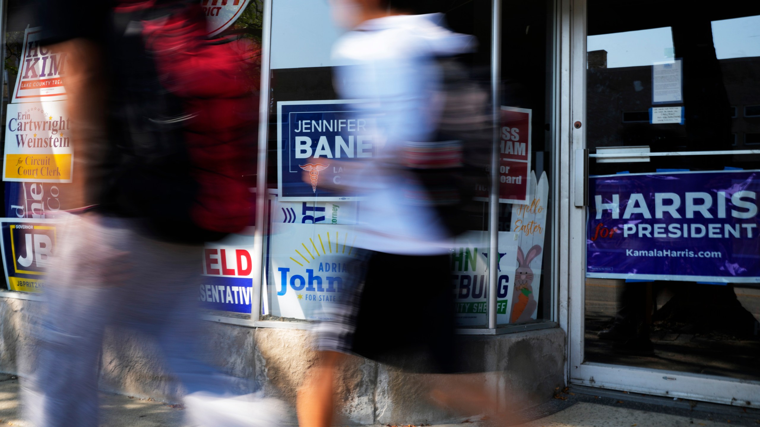 Pedestrians walk past the Waukegan Township Democrats office in Waukegan, Ill., Monday, Sept. 16, 2024. (AP Photo/Nam Y. Huh)