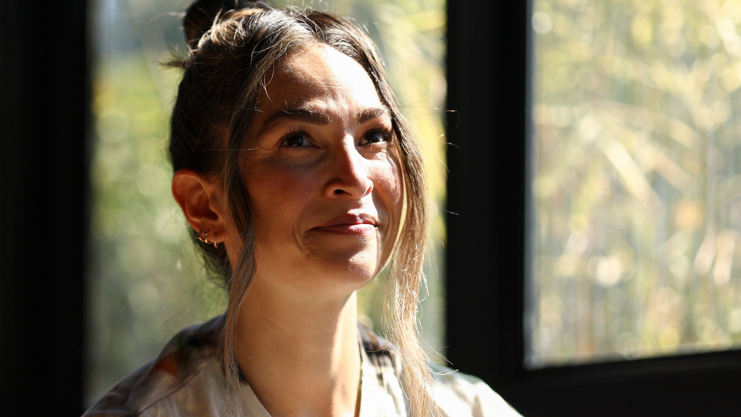 Headspace meditation teacher, Rosie Acosta, looks on in her sun room Monday, Sept. 30, 2024, in Woodland Hills, Calif. (AP Photo/Jessie Alcheh)