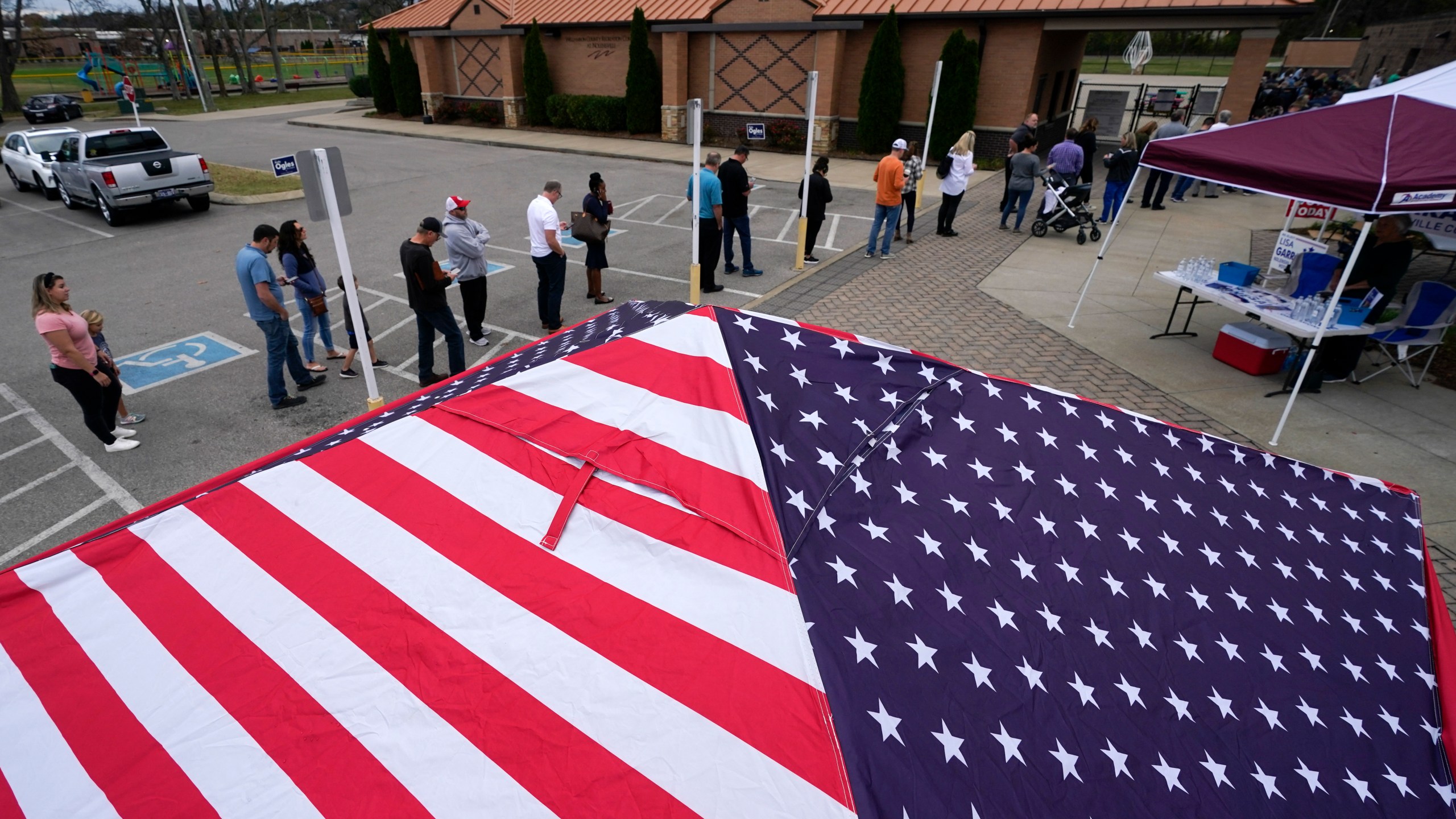 FILE - People line up to vote near tents set up by candidates' supporters, Nov. 8, 2022, in Nolensville, Tenn. (AP Photo/Mark Humphrey, File)