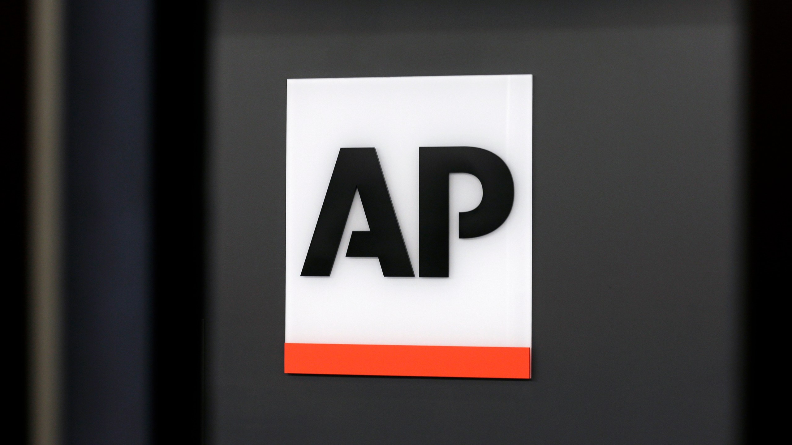 FILE - The Associated Press logo is displayed at the company's headquarters on April 18, 2017, in New York. (AP Photo/Jenny Kane, File)