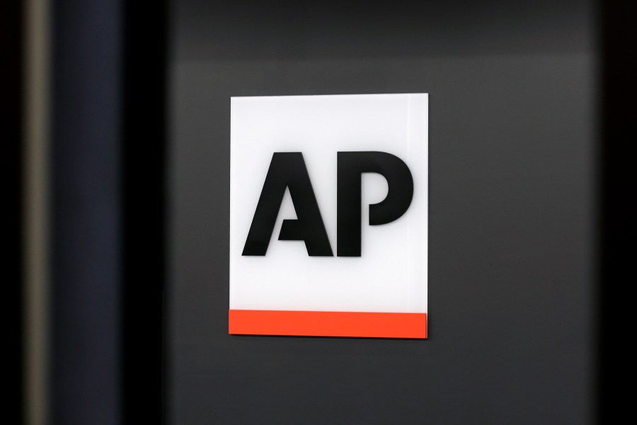 FILE - The Associated Press logo is displayed at the company's headquarters on April 18, 2017, in New York. (AP Photo/Jenny Kane, File)