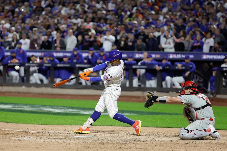 New York Mets' Francisco Lindor (12) connects for a grand slam home run against the Philadelphia Phillies during the sixth inning of Game 4 of the National League baseball playoff series, Wednesday, Oct. 9, 2024, in New York. (AP Photo/Adam Hunger)