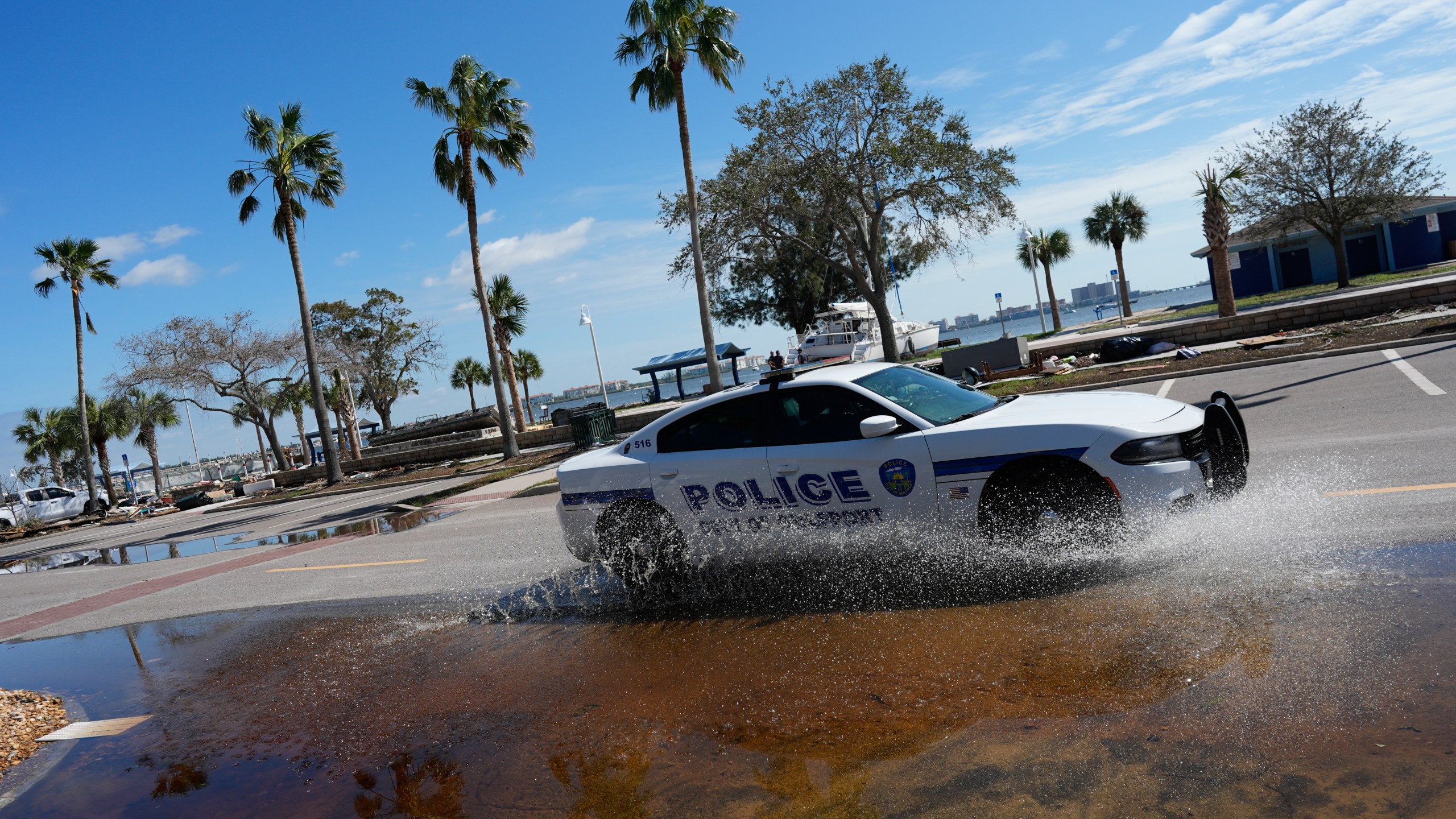 A police car patrols along a lightly flooded street following the passage of Hurricane Milton, in Gulfport, Fla., Thursday, Oct. 10, 2024. (AP Photo/Rebecca Blackwell)