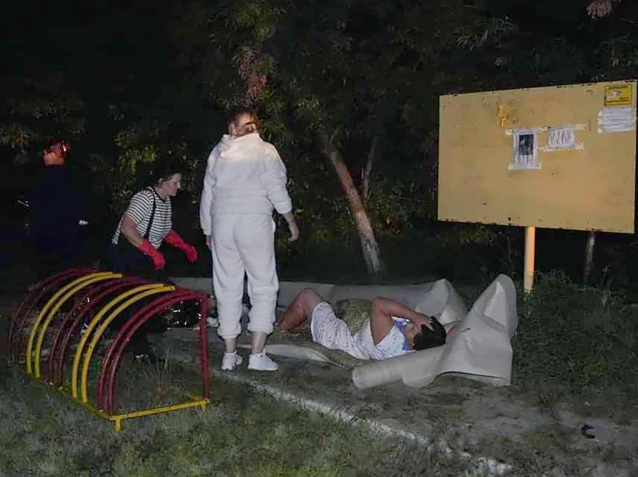 In this photo provided by the Ukrainian Emergency Service, Emergency workers provide first aid to a wounded resident after a Russian missile attack that killed four, injured ten in Odesa, Ukraine, late Thursday, Oct. 10, 2024. (Ukrainian Emergency Service via AP)