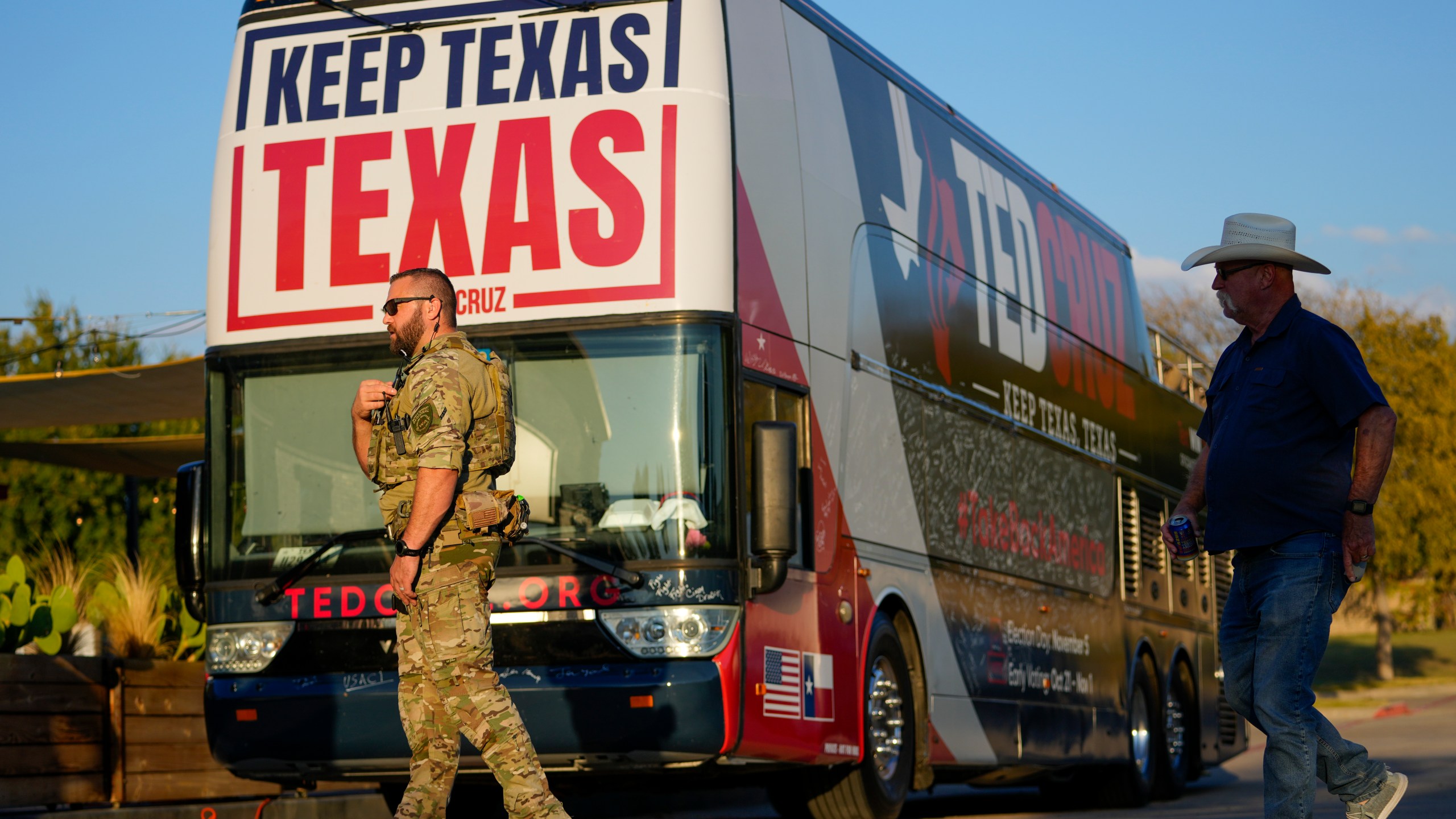 A security official stands near a bus during a campaign event for Sen. Ted Cruz, R-Texas, Saturday, Oct. 5, 2024, in Keller, Texas. (AP Photo/Julio Cortez)