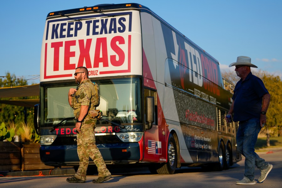 A security official stands near a bus during a campaign event for Sen. Ted Cruz, R-Texas, Saturday, Oct. 5, 2024, in Keller, Texas. (AP Photo/Julio Cortez)