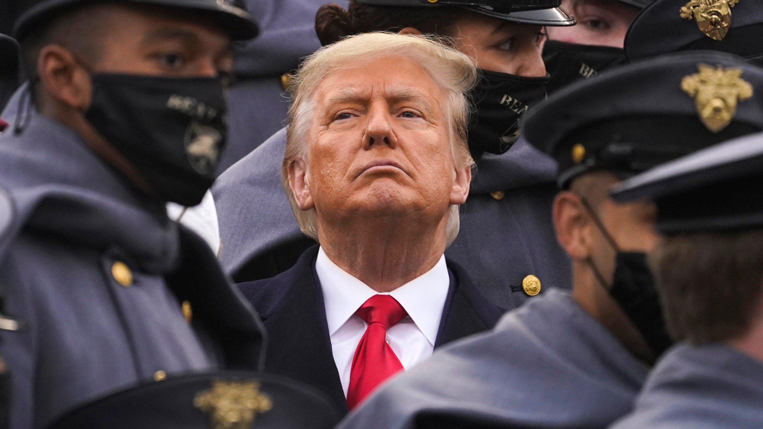 FILE - Surrounded by Army cadets, President Donald Trump watches the first half of the 121st Army-Navy Football Game, Dec. 12, 2020, in West Point, N.Y. (AP Photo/Andrew Harnik, File)