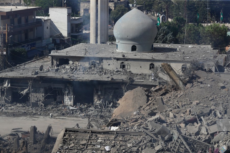 Destroyed shops and a mosque are seen on a commercial street that was hit Saturday night by Israeli airstrikes, in Nabatiyeh town, south Lebanon, Sunday, Oct. 13, 2024. (AP Photo/Mohammed Zaatari)