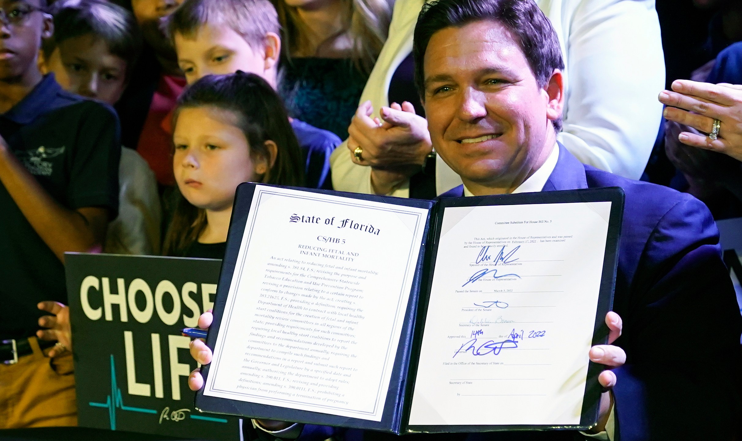 FILE - Florida Gov. Ron DeSantis holds up a 15-week abortion ban law after signing it on April 14, 2022, in Kissimmee, Fla. (AP Photo/John Raoux, File)