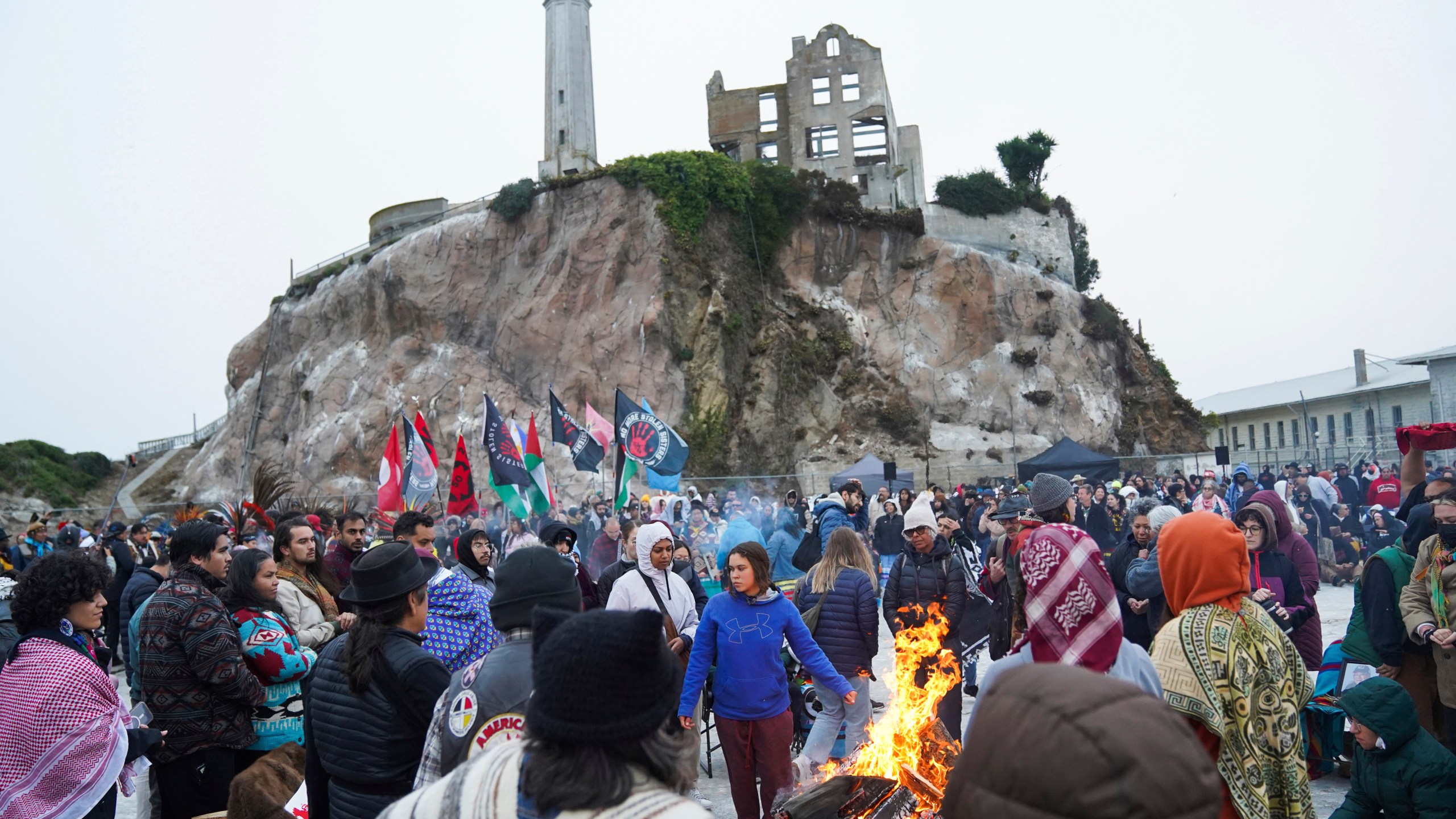 People attending the Indigenous Peoples Day Sunrise Gathering offer tobacco to the fire on Monday, Oct. 14, 2024, in San Francisco. (AP Photo/Minh Connors)