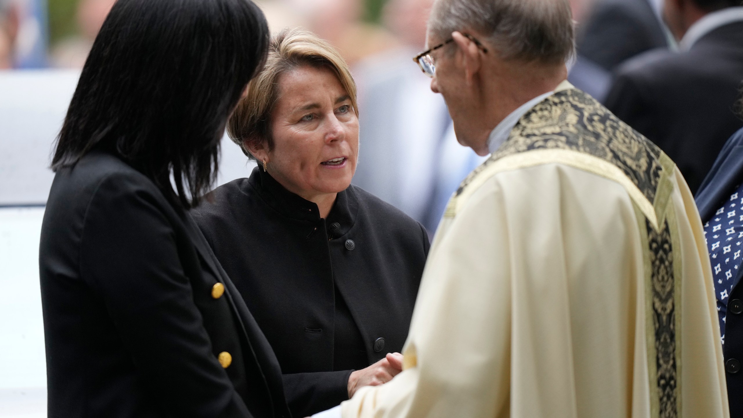 Massachusetts Gov. Maura Healey, center, speaks with Monsignor Kenneth Velo, right, following funeral services for Ethel Kennedy, wife of the late Sen. Robert F. Kennedy, at Our Lady of Victory church, Monday, Oct. 14, 2024, in Centerville, Mass. (AP Photo/Steven Senne)