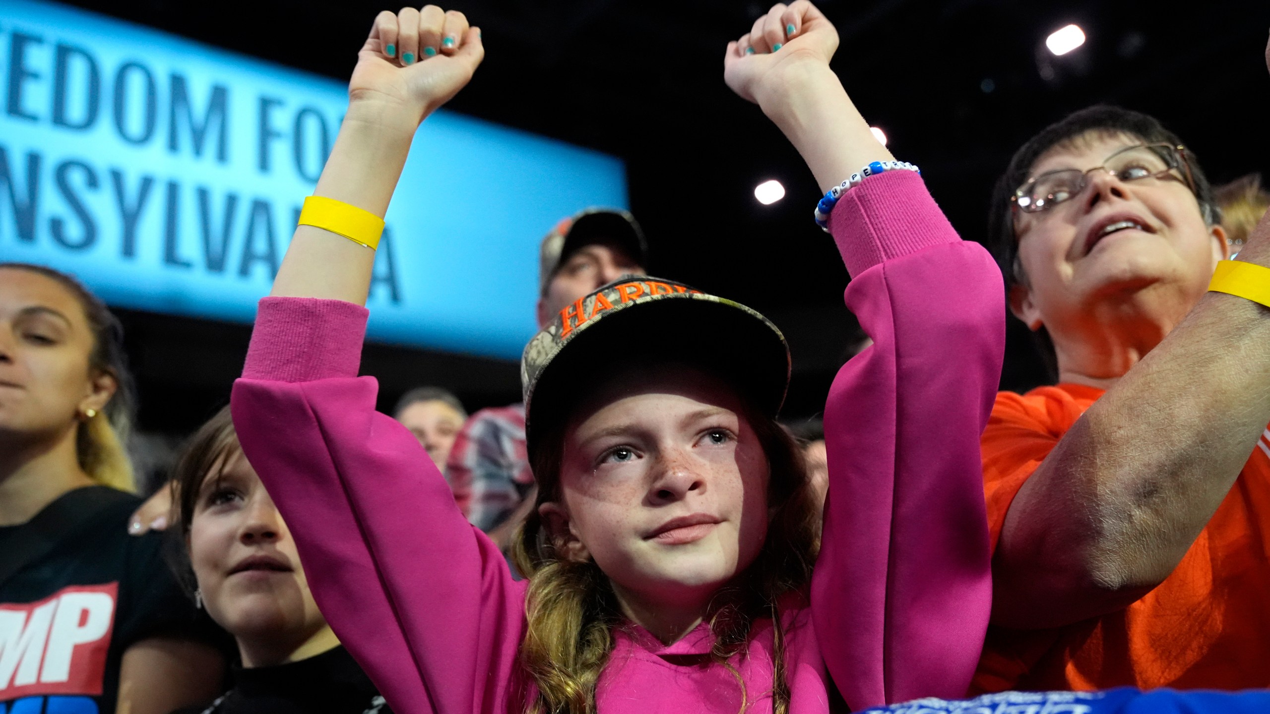 A young attendee cheers as Democratic presidential nominee Vice President Kamala Harris speaks during a campaign rally at Erie Insurance Arena, in Erie, Pa., Monday, Oct. 14, 2024. (AP Photo/Jacquelyn Martin)