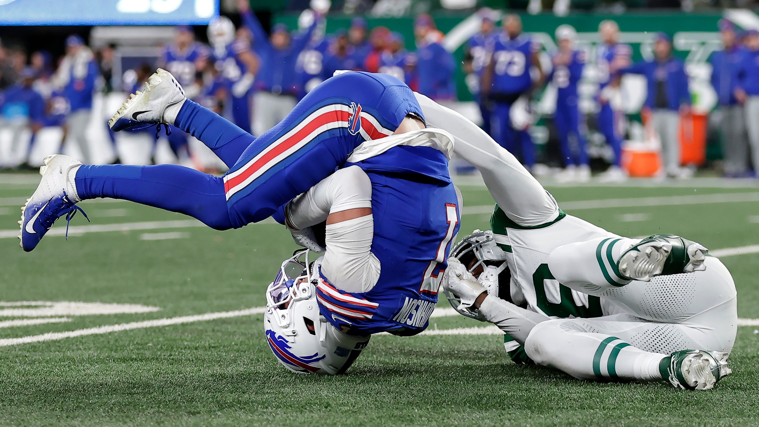 Buffalo Bills cornerback Taron Johnson, left, intercepts a pass intended for New York Jets wide receiver Mike Williams, right, during the second half of an NFL football game in East Rutherford, N.J., Monday, Oct. 14, 2024. (AP Photo/Adam Hunger)