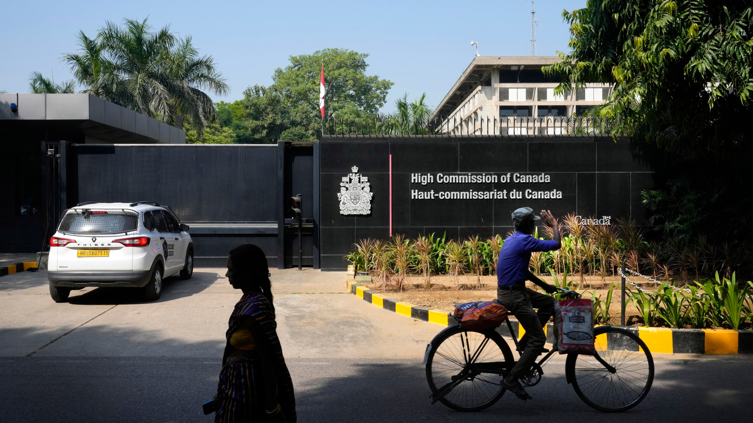 A cyclist pedals past the Canadian high commission in New Delhi, India, Tuesday, Oct. 15, 2024 after India and Canada expelled each other’s top diplomats over an ongoing dispute about the killing of a Sikh activist in Canada. (AP Photo/Manish Swarup)