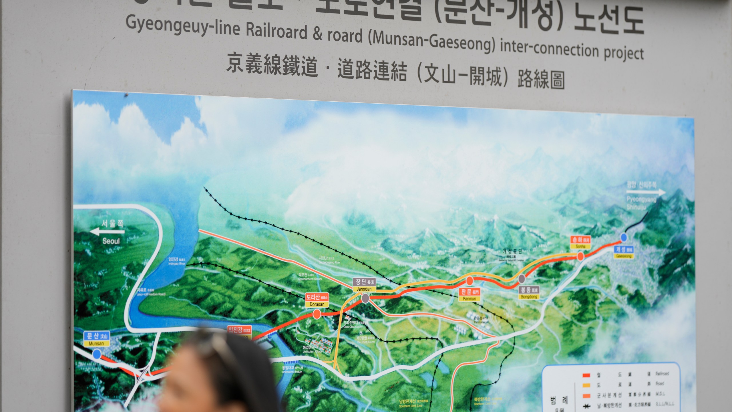 A visitor walks by a map of railroad and road between two Koreas cities, South's Munsan and North's Kaesong, at the Imjingak Pavilion in Paju, South Korea, Tuesday, Oct. 15, 2024. (AP Photo/Lee Jin-man)