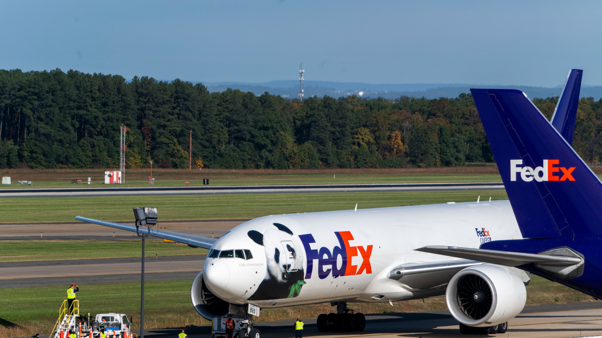 A FedEx cargo plane arrives at Dulles International Airport carrying giant pandas from China on Tuesday, Oct. 15, 2024 in Sterling, Va. (AP Photo/Kevin Wolf)