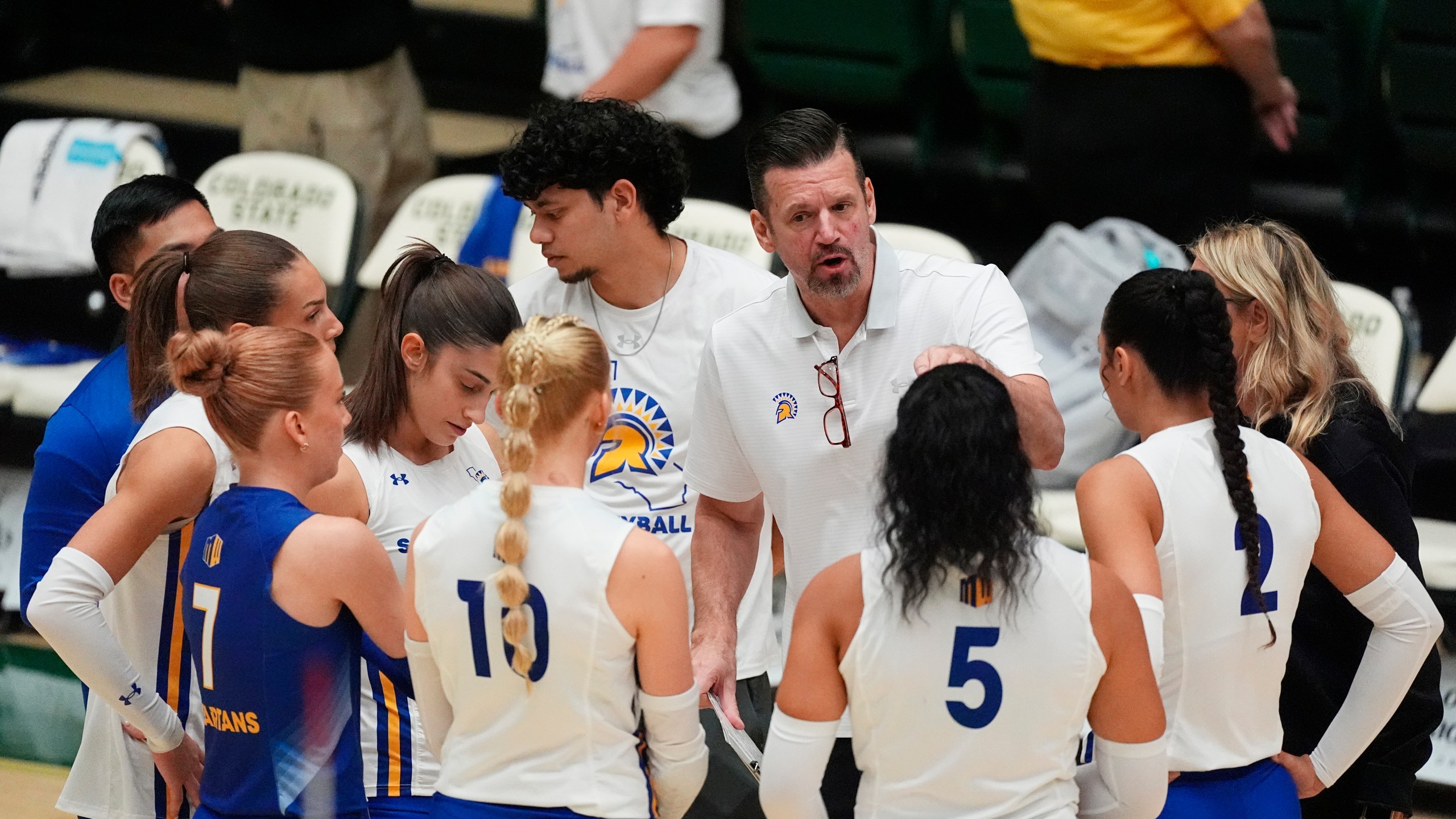 San Jose State head coach Todd Kress, center back, talks to his players during a timeout during the first set of an NCAA college volleyball match against Colorado State, Thursday, Oct. 3, 2024, in Fort Collins, Colo. (AP Photo/David Zalubowski)