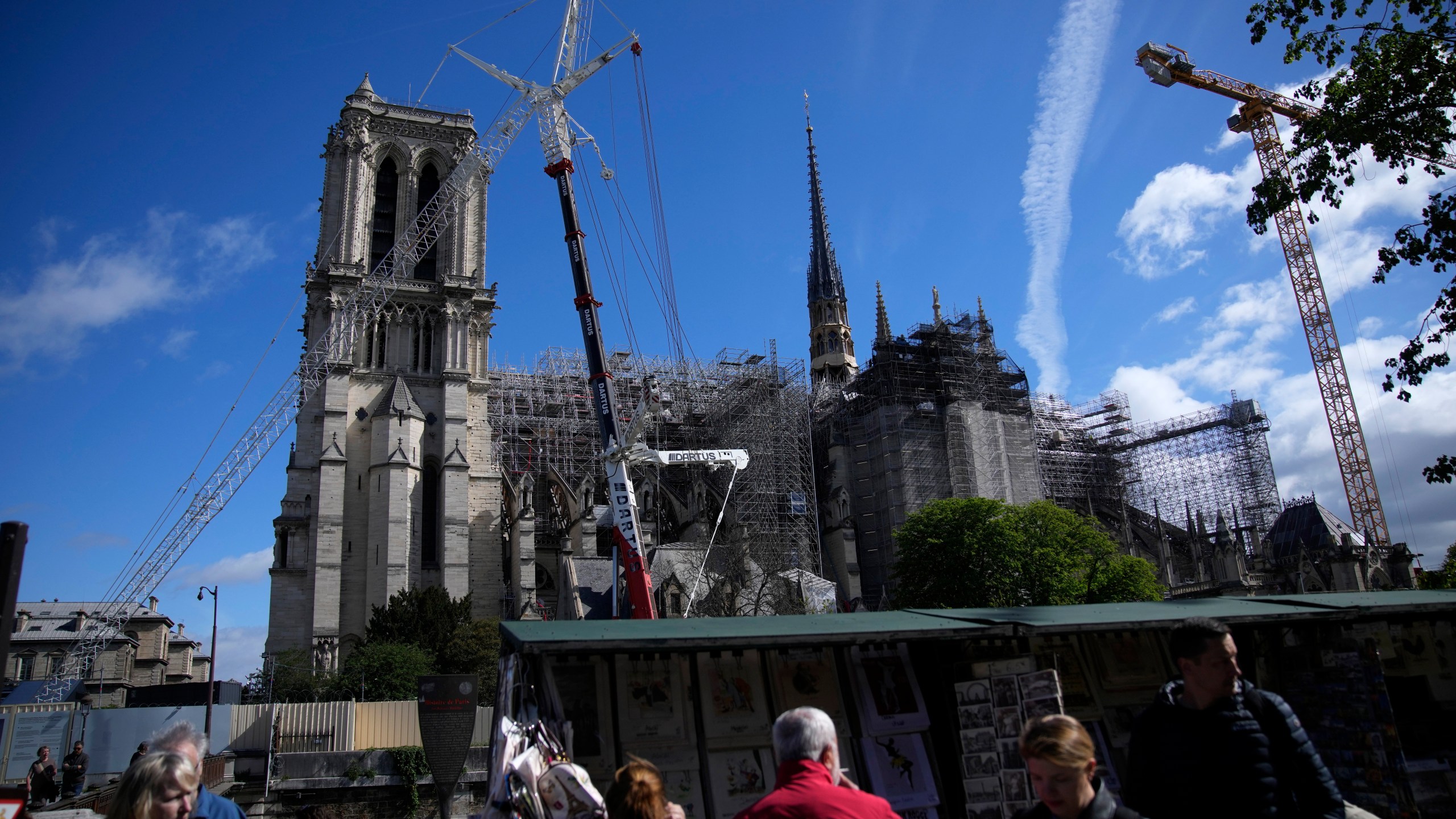 FILE - People walk past Notre Dame Cathedral in Paris, France, April 15, 2024. (AP Photo/Christophe Ena, FILE)