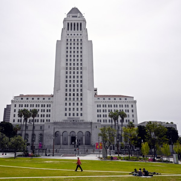 FILE - A few people use Grand Park at the foot of Los Angeles City Hall, Tuesday, March 31, 2020, in Los Angeles. (AP Photo/Mark J. Terrill, File)