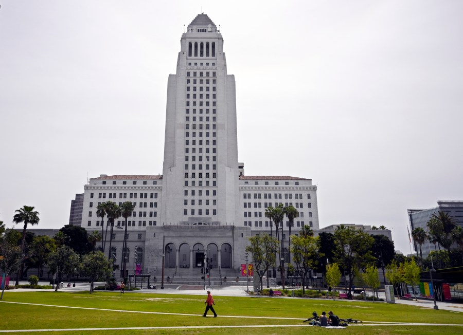 FILE - A few people use Grand Park at the foot of Los Angeles City Hall, Tuesday, March 31, 2020, in Los Angeles. (AP Photo/Mark J. Terrill, File)