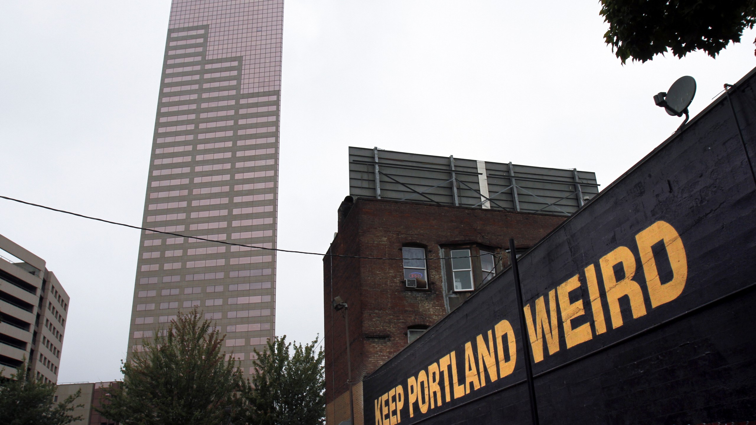 FILE - A downtown building displays a popular slogan in relation to the city in Portland, Ore., Sept. 19, 2012. (AP Photo/Don Ryan, File)