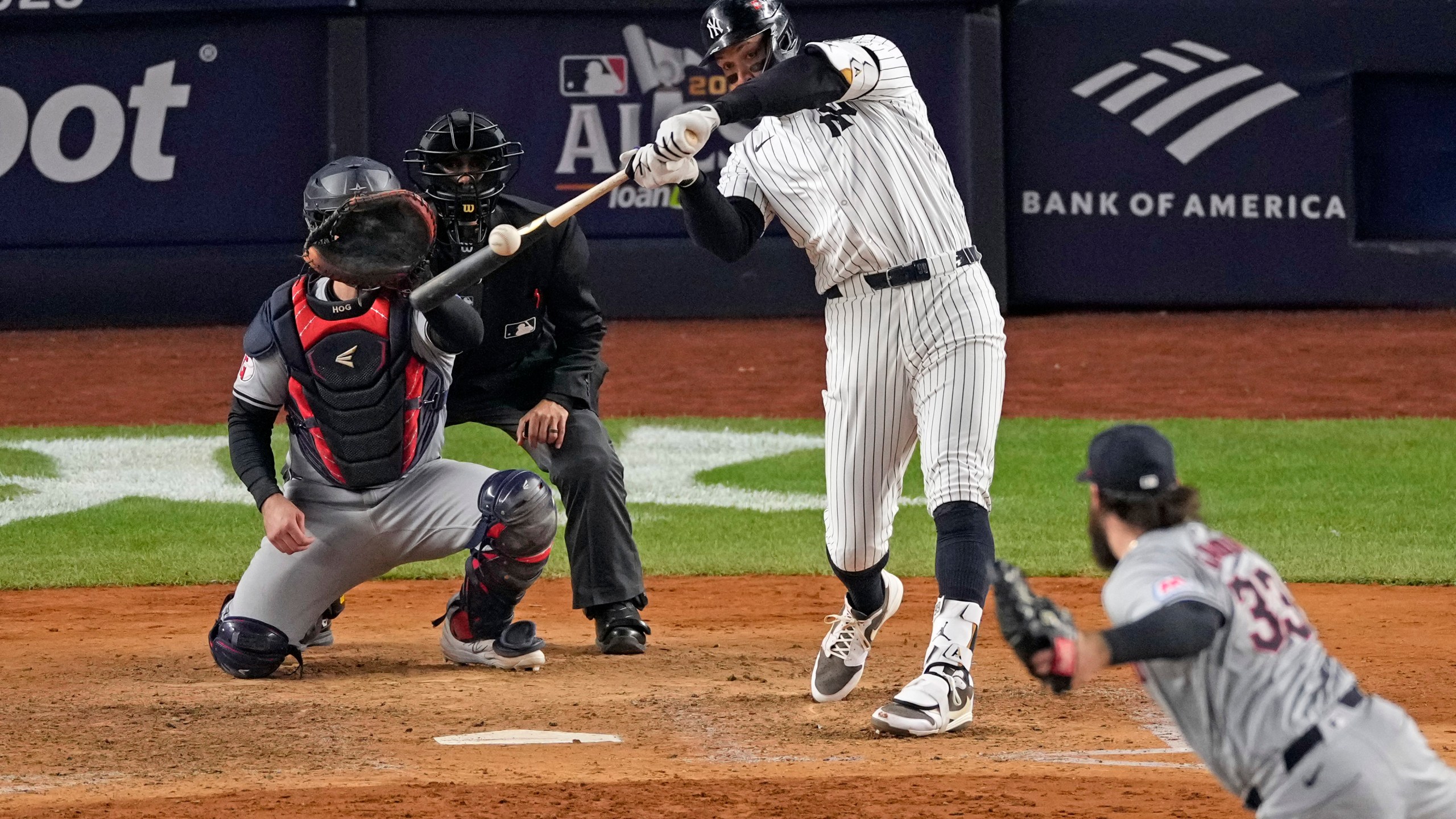 New York Yankees' Aaron Judge, center, hits a two-run home run off Cleveland Guardians relief pitcher Hunter Gaddis (33) during the seventh inning in Game 2 of the baseball AL Championship Series Tuesday, Oct. 15, 2024, in New York. (AP Photo/Seth Wenig)