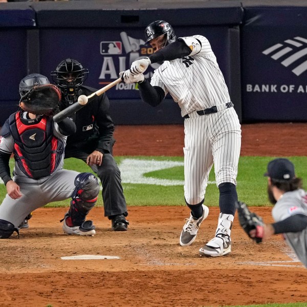 New York Yankees' Aaron Judge, center, hits a two-run home run off Cleveland Guardians relief pitcher Hunter Gaddis (33) during the seventh inning in Game 2 of the baseball AL Championship Series Tuesday, Oct. 15, 2024, in New York. (AP Photo/Seth Wenig)