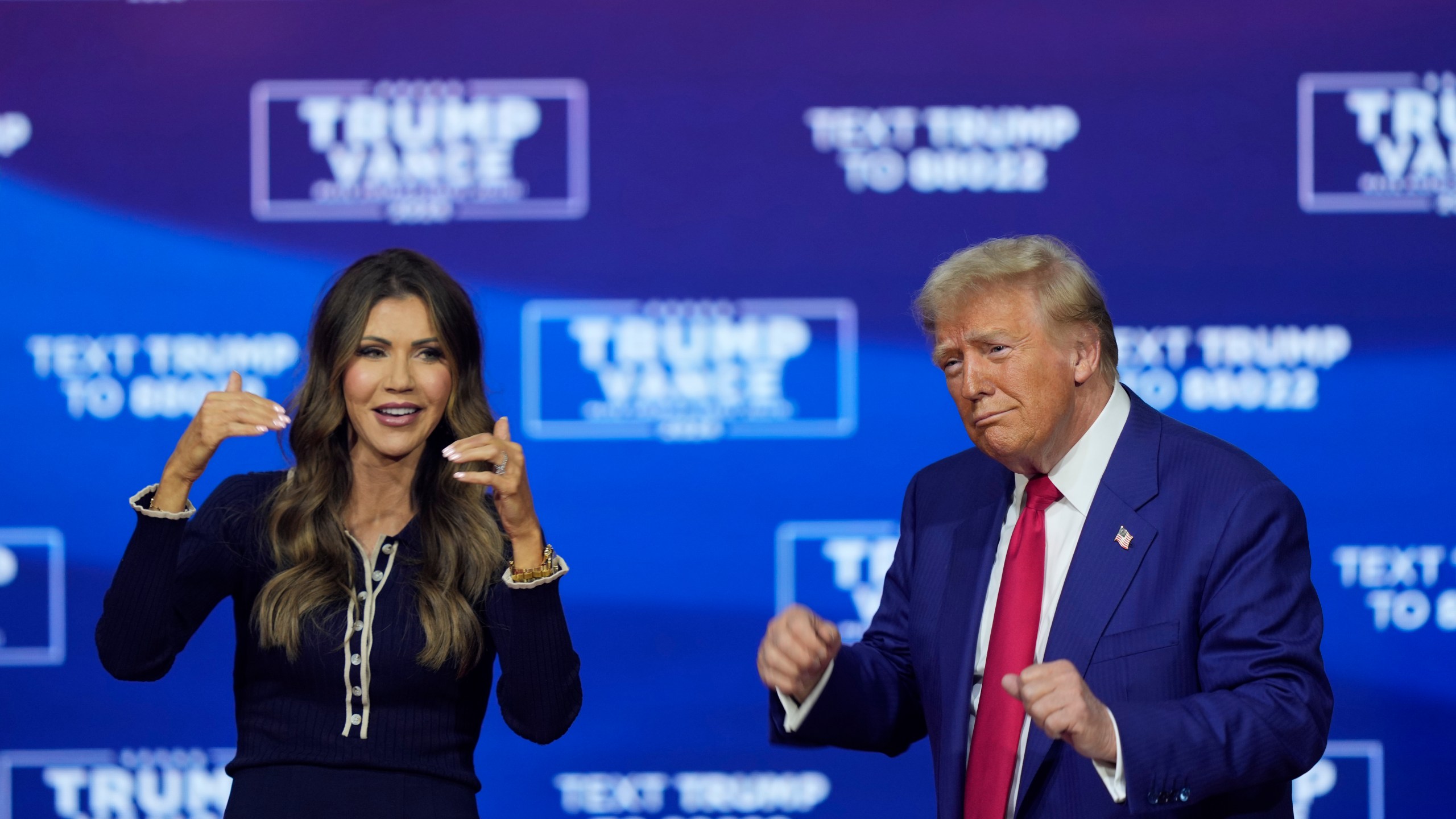 Republican presidential nominee former President Donald Trump and South Dakota Gov. Kristi Noem dance to the song "Y.M.C.A." at a campaign town hall at the Greater Philadelphia Expo Center & Fairgrounds, Monday, Oct. 14, 2024, in Oaks, Pa. (AP Photo/Matt Rourke)