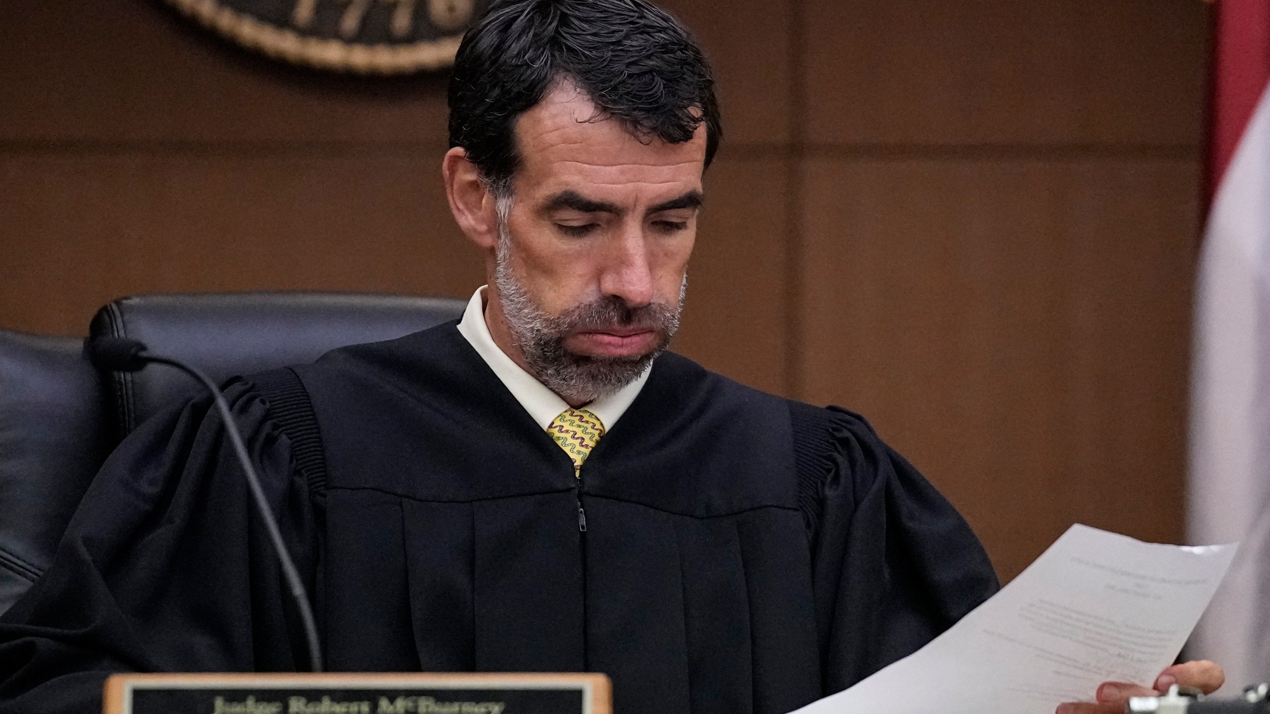 FILE - Fulton County Superior Court Judge Robert McBurney looks through paperwork, Monday, Aug. 14, 2023, in Atlanta. (AP Photo/Brynn Anderson, File)