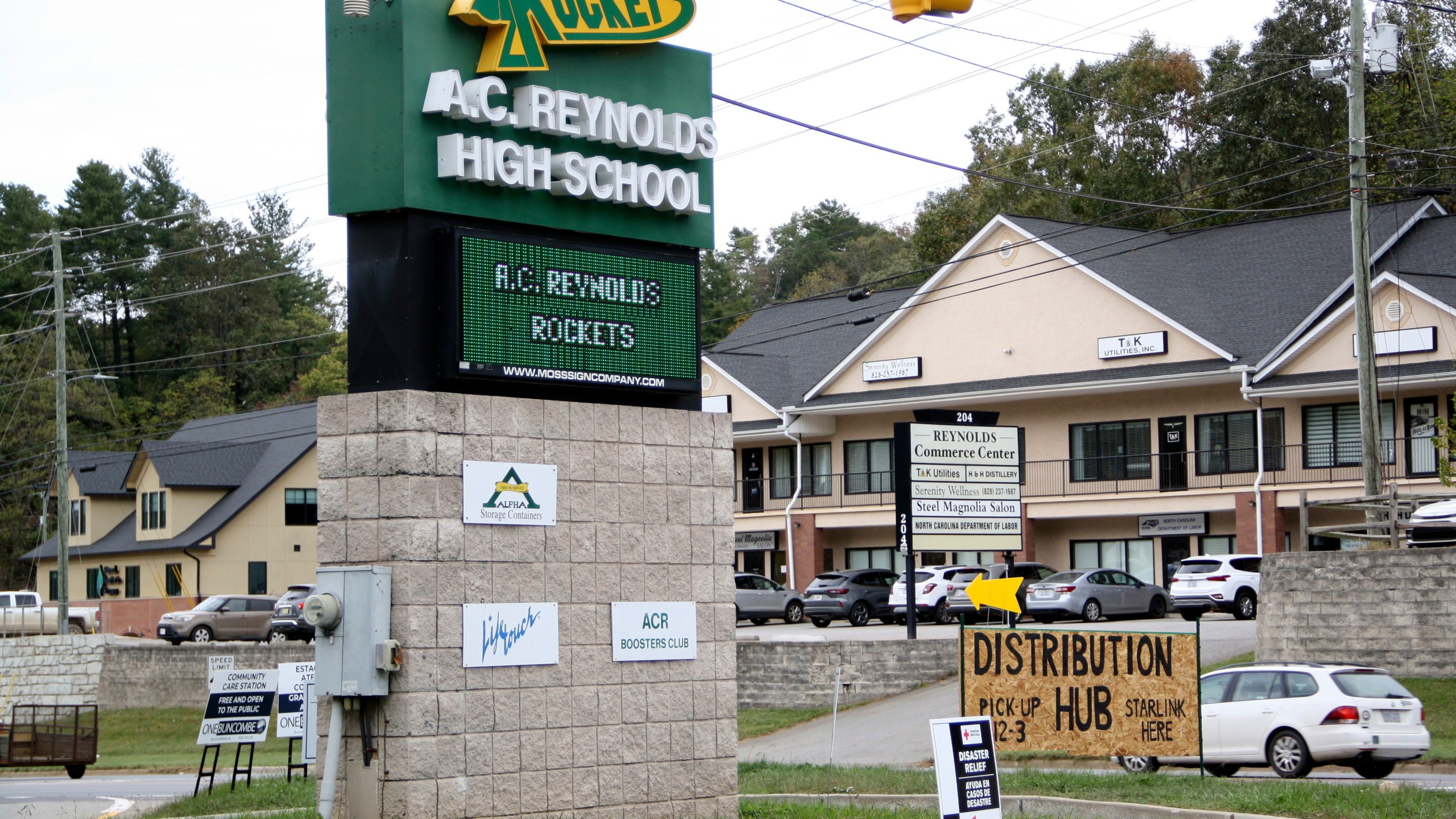 Signs are seen at a FEMA Disaster Recovery Center at A.C. Reynolds High School in Asheville, N.C., Tuesday, Oct. 15, 2024. (AP Photo/Makiya Seminera)