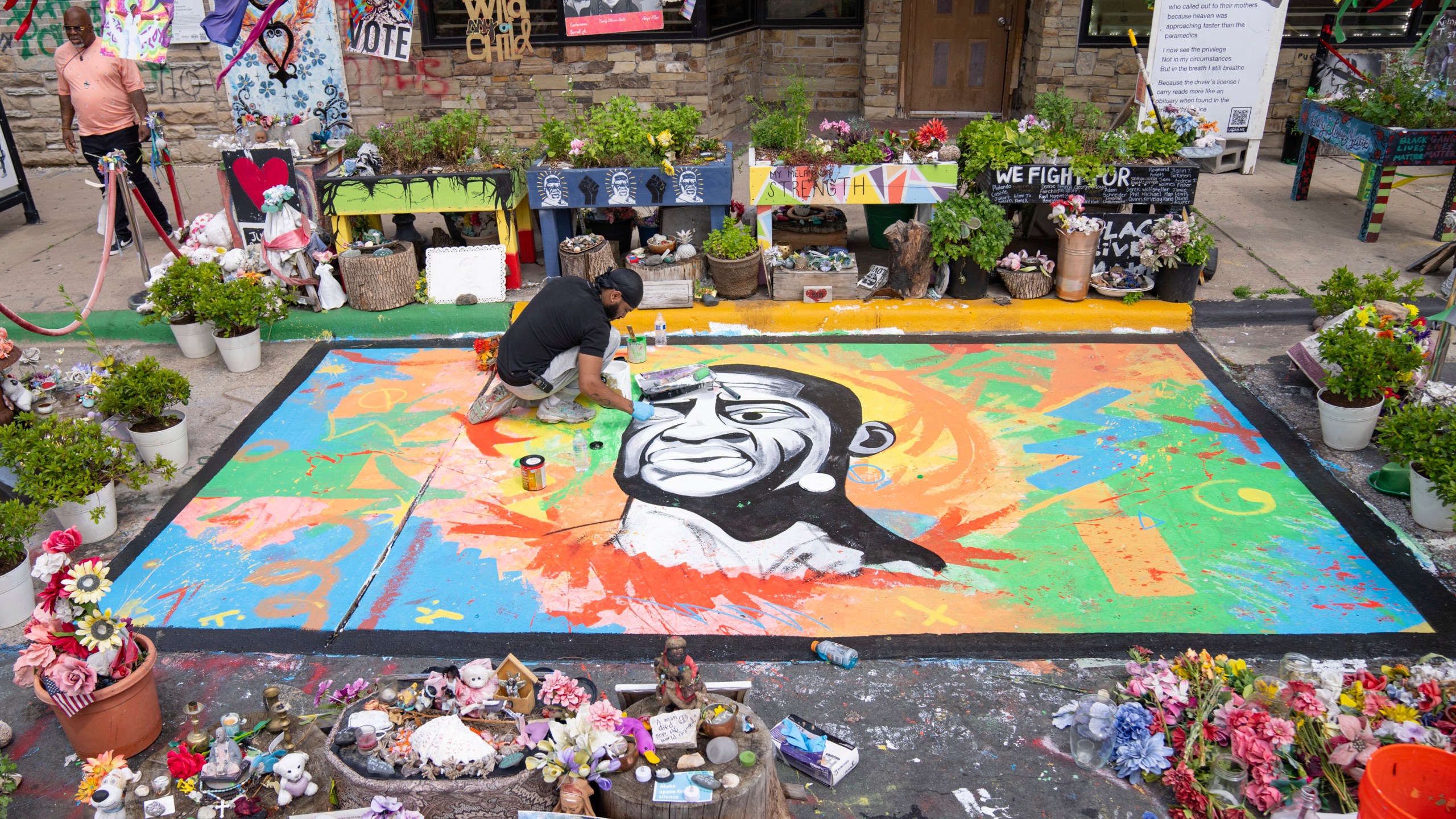 FILE - Antonio Jenkins paints a mural of George Floyd at the site where he was murdered by a police officer in 2020 at George Floyd Square in Minneapolis, May 25, 2024. (Alex Kormann/Star Tribune via AP, File)