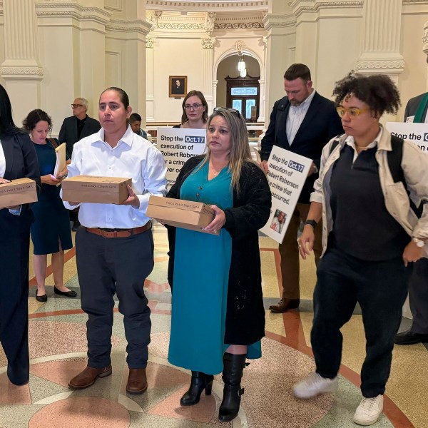 Casandra Rivera, left, Anna Vasquez, second from left, and Elizabeth Ramirez, center, of the "San Antonio 4" group, hold boxes with petitions being delivered in the Texas State capitol for Texas Gov. Greg Abbott seeking the pardoning of Robert Roberson's execution, Wednesday, Oct. 16, 2024 in Austin, Texas. Roberson, 57, is scheduled to receive a lethal injection on Oct. 17, for the 2002 killing of his 2-year-old daughter, Nikki Curtis, in the East Texas city of Palestine. Roberson has long proclaimed his innocence. (AP Photo/Nadia Lathan)