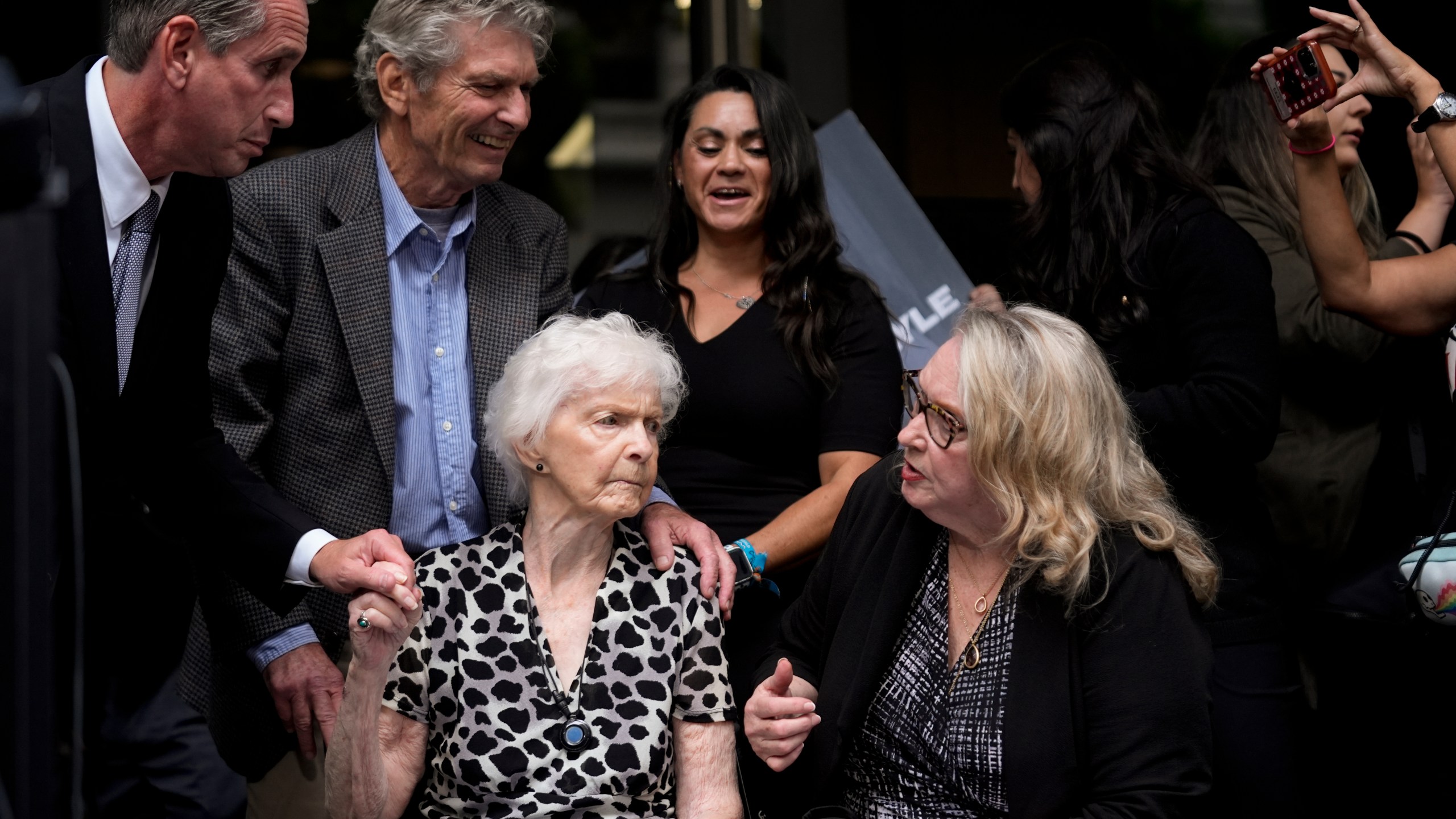 Kitty Menendez' sister, Joan Andersen VanderMolen, bottom left, and niece Karen VanderMolen, right, sit together during a press conference to announce developments on the case of brothers Erik and Lyle Menendez, Wednesday, Oct. 16, 2024, in Los Angeles. (AP Photo/Damian Dovarganes)