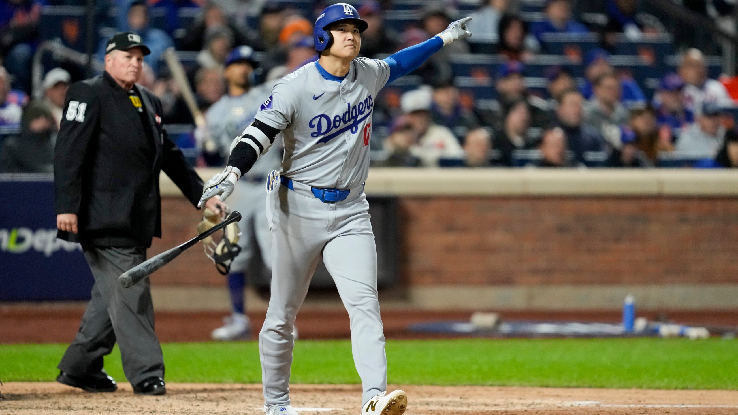 Los Angeles Dodgers' Shohei Ohtani celebrates his three-run home run against the New York Mets during the eighth inning in Game 3 of a baseball NL Championship Series, Wednesday, Oct. 16, 2024, in New York. (AP Photo/Ashley Landis)