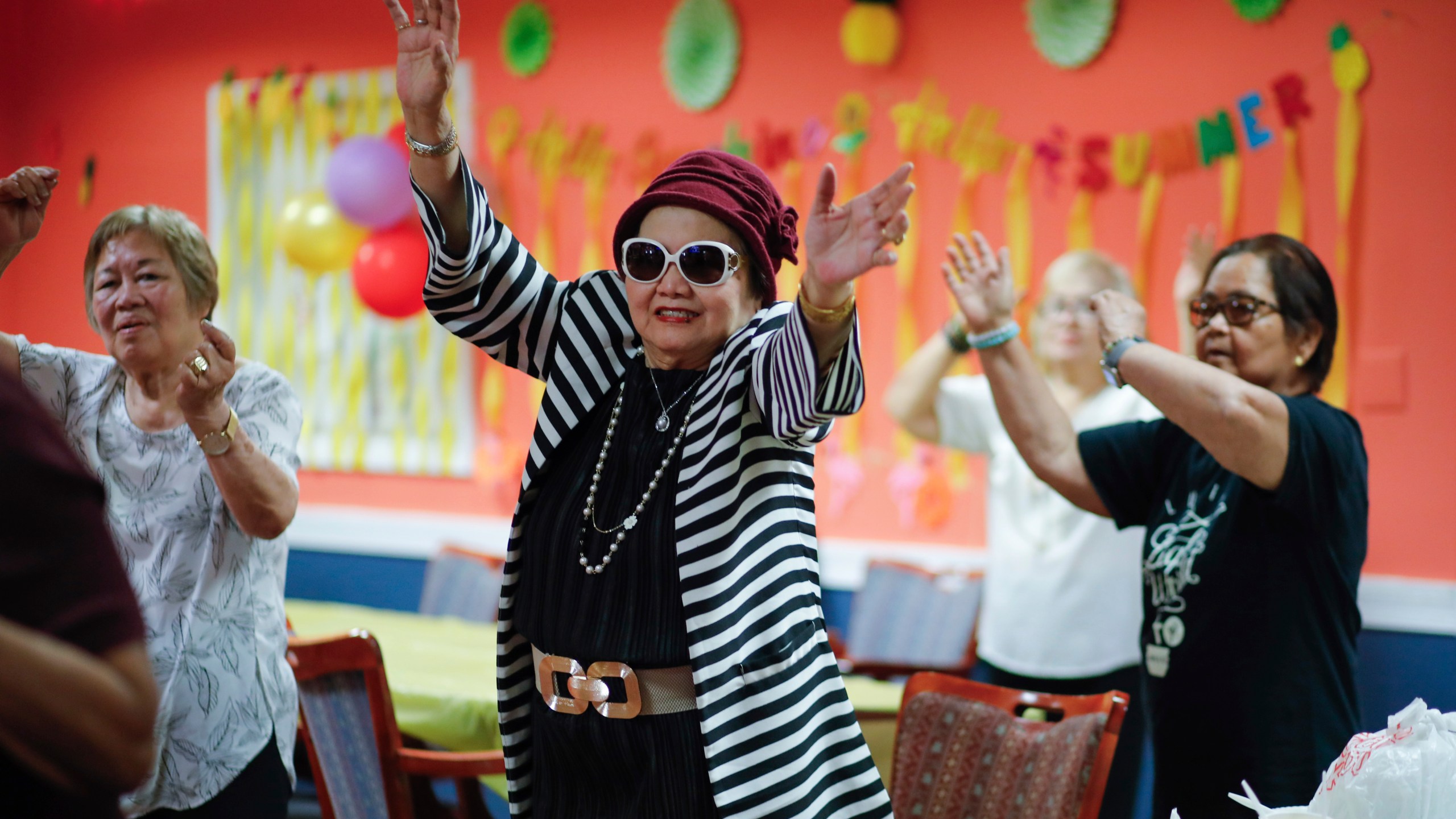 People attend a Zumba exercise class at Sunshine Adult Day Center in Bergenfield, N.J., Monday, Aug. 26, 2024. (AP Photo/Kena Betancur)