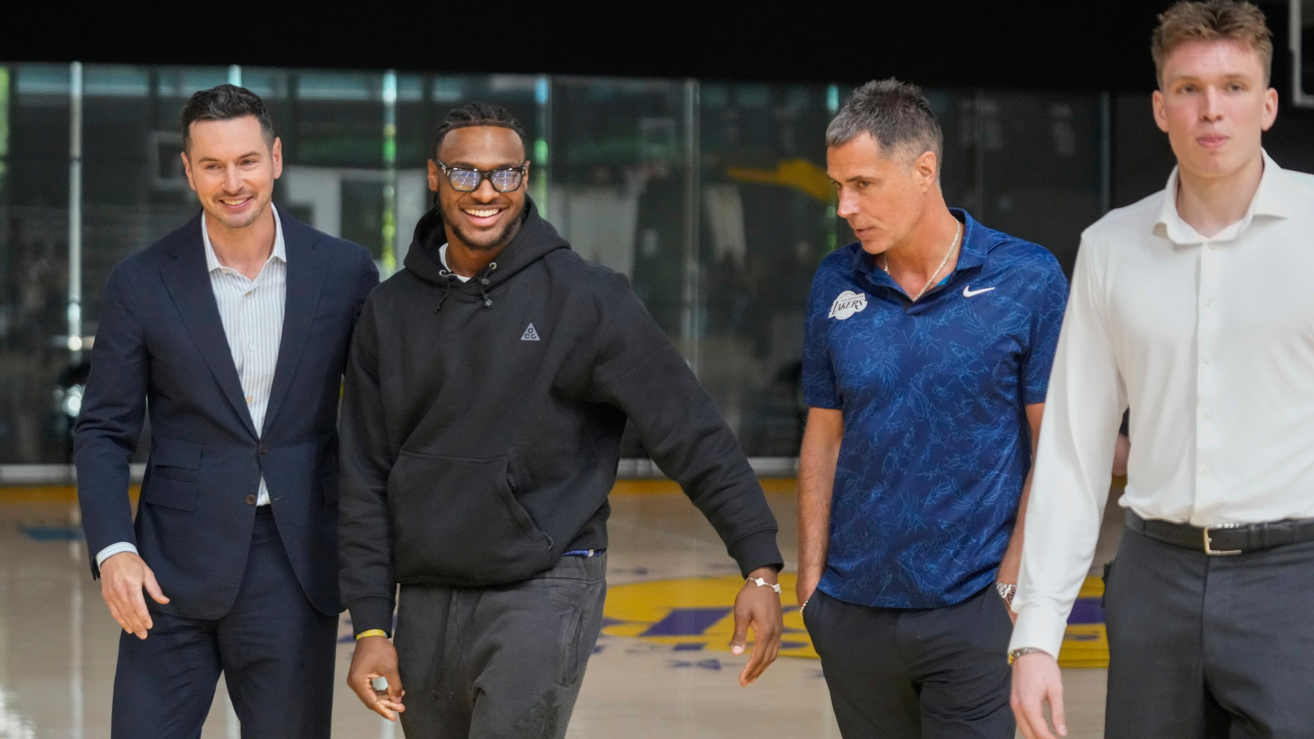 FILE - Los Angeles Lakers' head coach JJ Redick, and Vice President of Basketball Operations and General Manager, Rob Pelinka, third from left, arrive to introduce their new NBA basketball team's players, Bronny James, second from left, and Dalton Knecht at a news conference in El Segundo, Calif., Tuesday, July 2, 2024. (AP Photo/Damian Dovarganes, File)