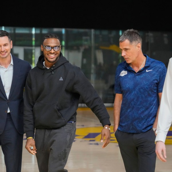 FILE - Los Angeles Lakers' head coach JJ Redick, and Vice President of Basketball Operations and General Manager, Rob Pelinka, third from left, arrive to introduce their new NBA basketball team's players, Bronny James, second from left, and Dalton Knecht at a news conference in El Segundo, Calif., Tuesday, July 2, 2024. (AP Photo/Damian Dovarganes, File)