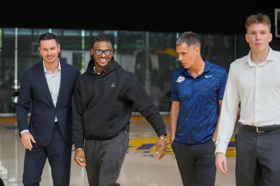 FILE - Los Angeles Lakers' head coach JJ Redick, and Vice President of Basketball Operations and General Manager, Rob Pelinka, third from left, arrive to introduce their new NBA basketball team's players, Bronny James, second from left, and Dalton Knecht at a news conference in El Segundo, Calif., Tuesday, July 2, 2024. (AP Photo/Damian Dovarganes, File)