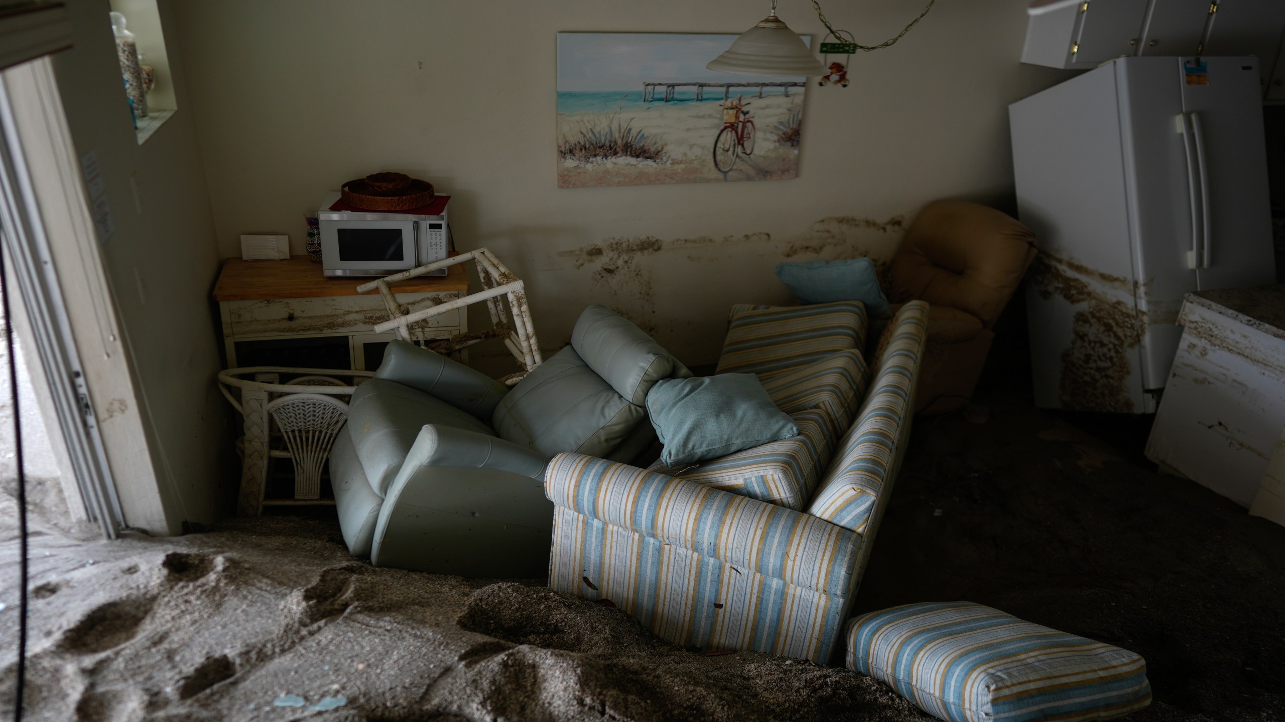 Several feet of sand fills a condo following the passage of Hurricane Milton, at YCA Vacation Rental in Venice, Fla., Friday, Oct. 11, 2024. (AP Photo/Rebecca Blackwell)