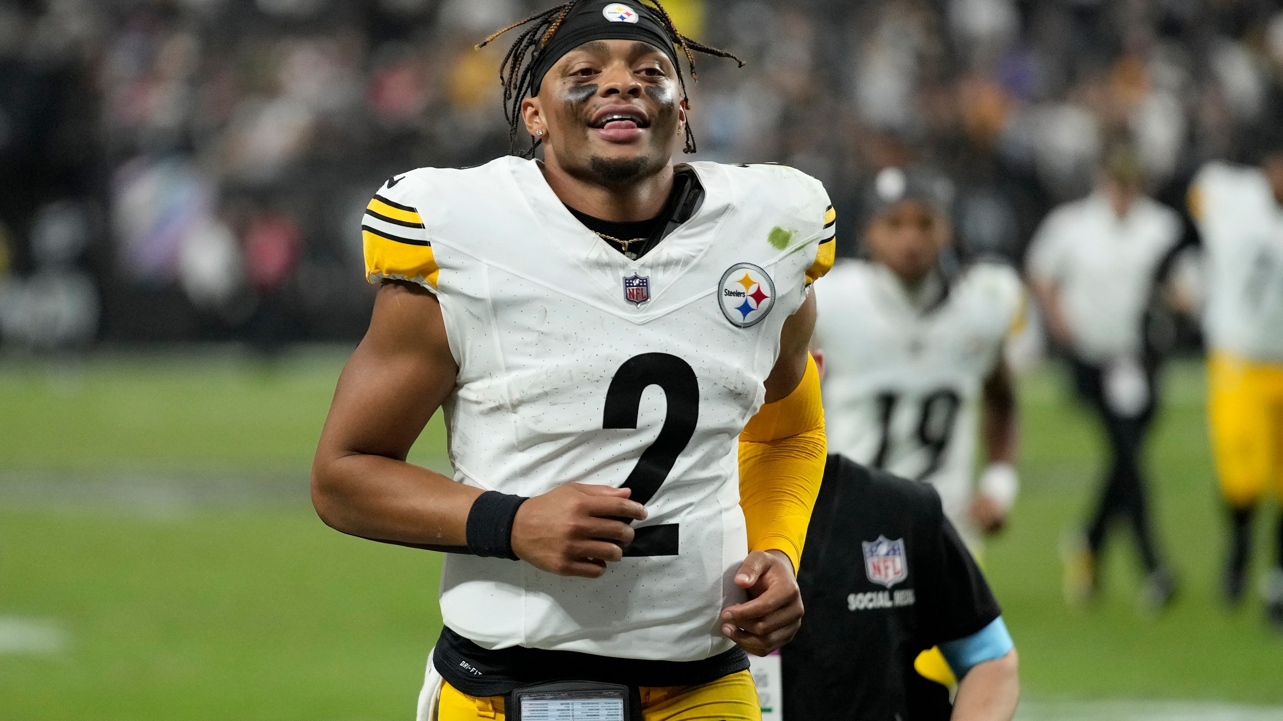 Pittsburgh Steelers quarterback Justin Fields (2) smiles as he jogs off the field after an NFL football game against the Las Vegas Raiders in Las Vegas, Sunday, Oct. 13, 2024. (AP Photo/John Locher)