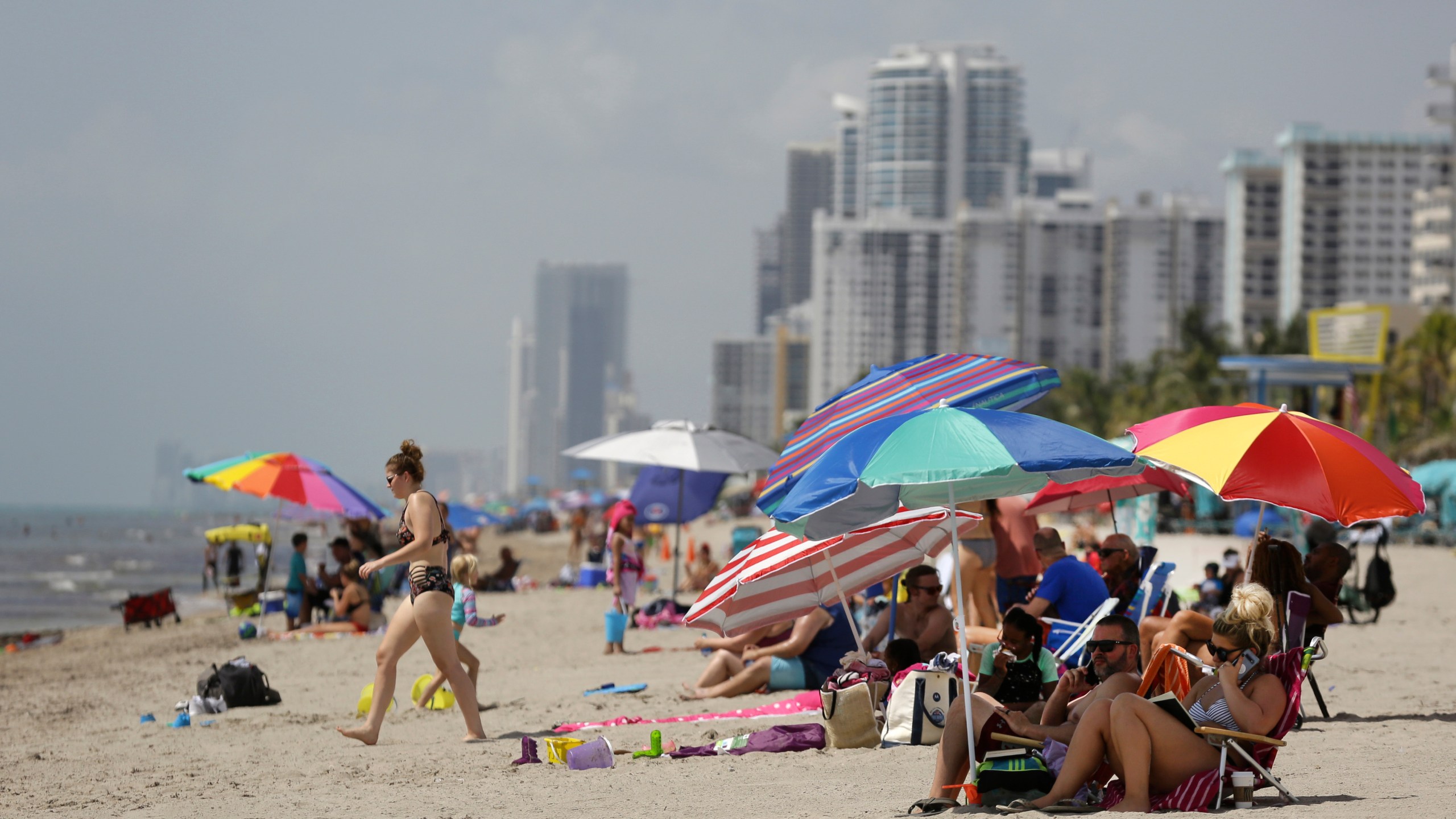 FILE - People sit on Hollywood Beach on July 2, 2020, in Hollywood, Fla. (AP Photo/Lynne Sladky, File)