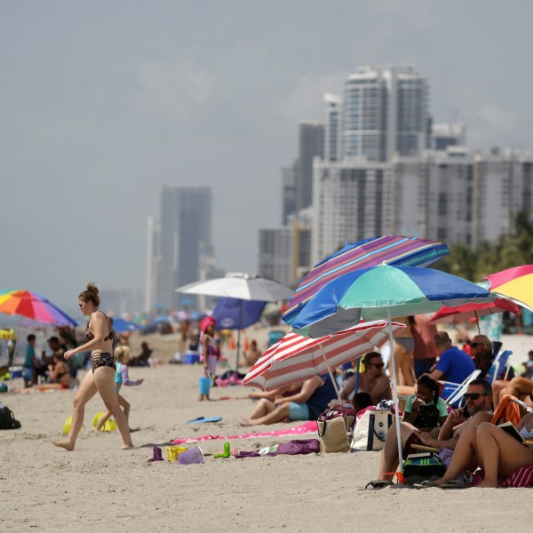 FILE - People sit on Hollywood Beach on July 2, 2020, in Hollywood, Fla. (AP Photo/Lynne Sladky, File)