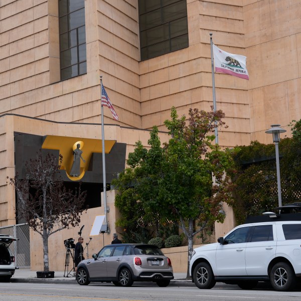 Television news crews report the largest single child sex abuse settlement with a Catholic archdiocese outside the Cathedral of Our Lady of Angels in Los Angeles, Thursday, Oct. 17, 2024. The Archdiocese of Los Angeles has agreed to pay $880 million to victims of clergy sexual abuse dating back decades. (AP Photo/Damian Dovarganes)