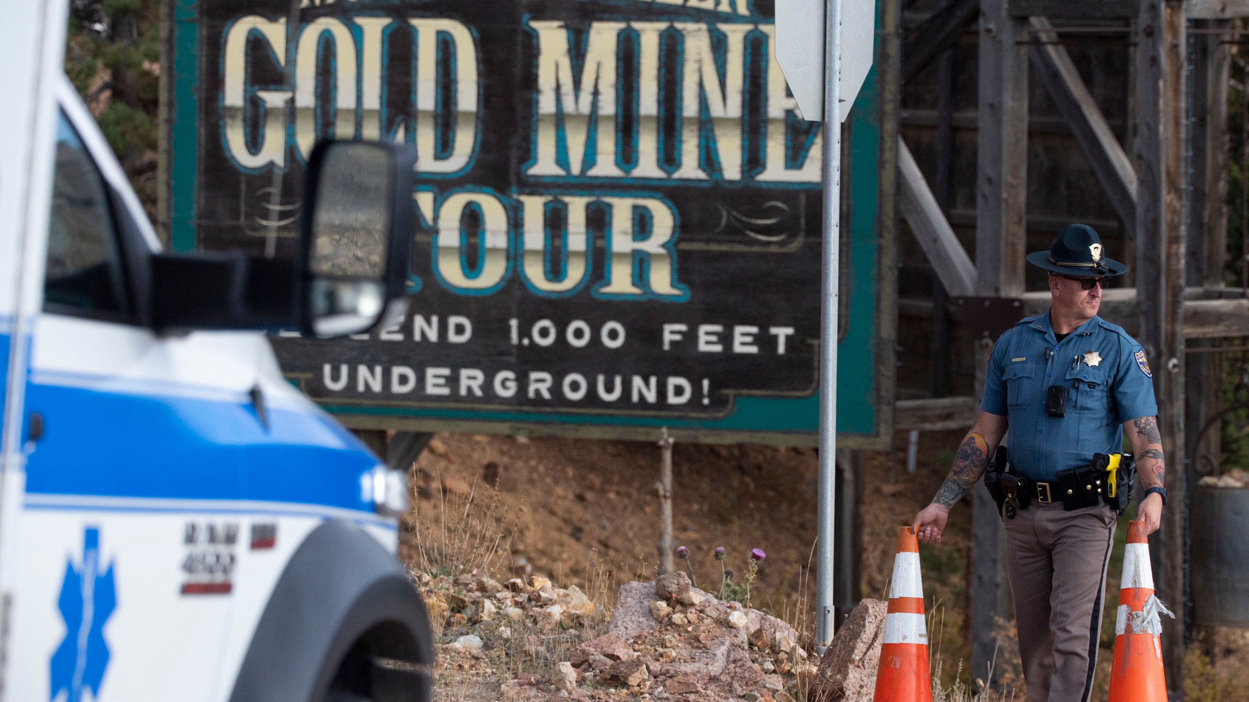 A police officer moves a barrier for an emergency vehicle Thursday, Oct. 9, 2024, at Mollie Kathleen Gold Mine in Cripple Creek, Colo. (Arthur H. Trickett-Wile/The Gazette via AP)