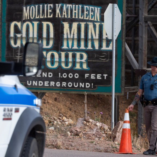 A police officer moves a barrier for an emergency vehicle Thursday, Oct. 9, 2024, at Mollie Kathleen Gold Mine in Cripple Creek, Colo. (Arthur H. Trickett-Wile/The Gazette via AP)